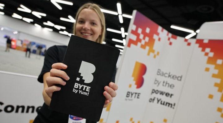 Woman holding a byte by yum notebook