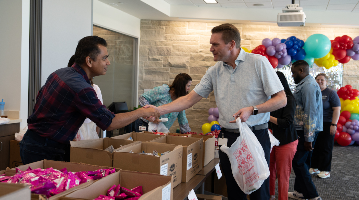 Chris Turner shaking hands with an employee