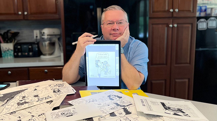 Rick Maynard draws a cartoon.